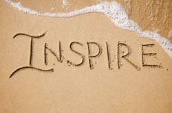graphic of the word inspire written in the sand