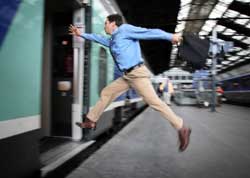 photo of man leaping onto train