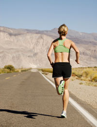 photo of woman running on deserted highway